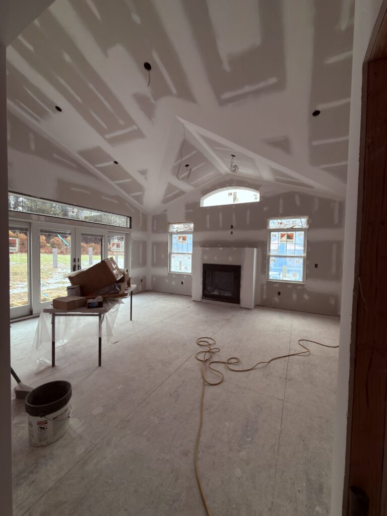 Vaulted living room remodel with fireplace - Action Construction